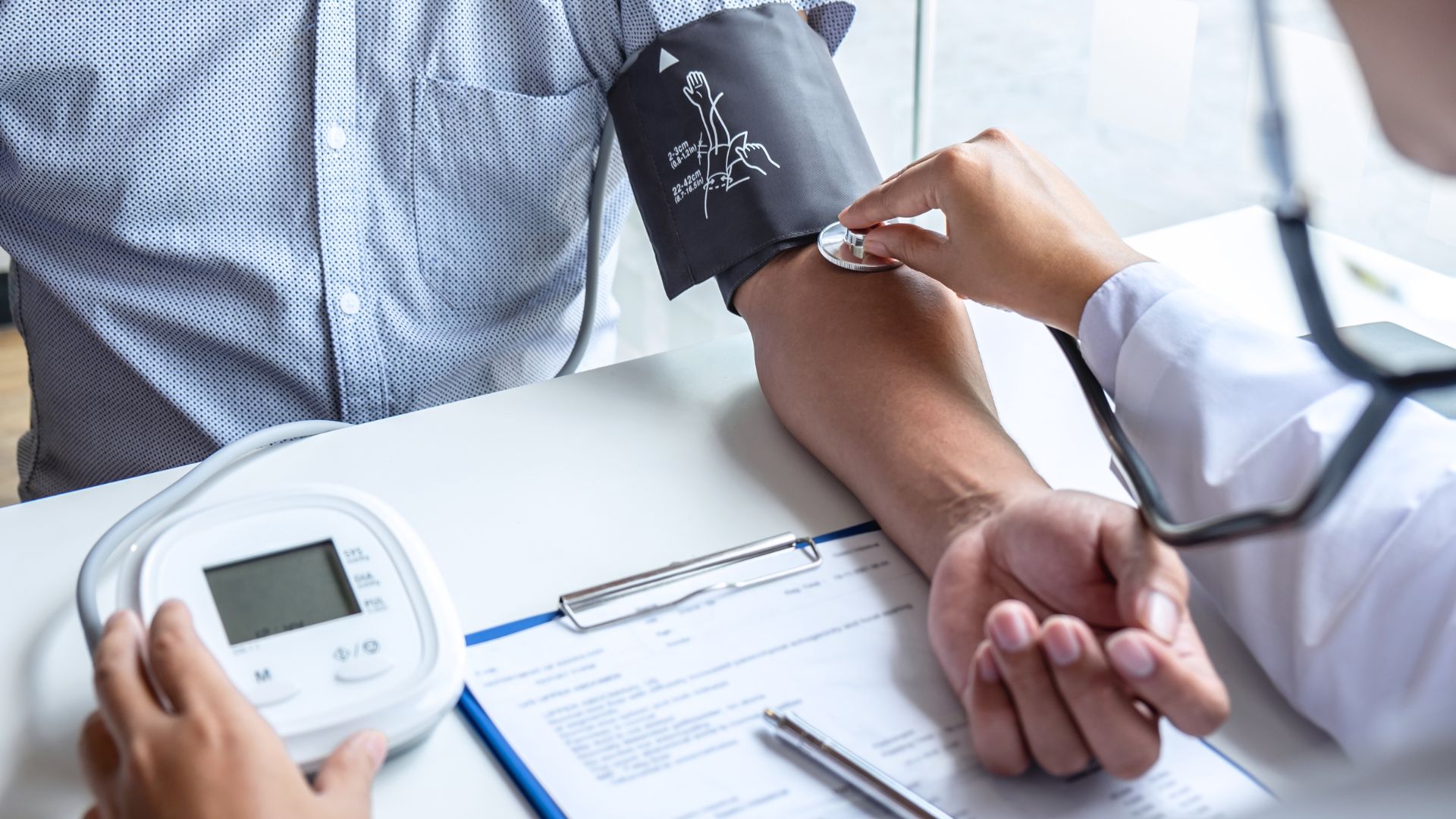 Doctor measuring patient's blood pressure during medical checkup