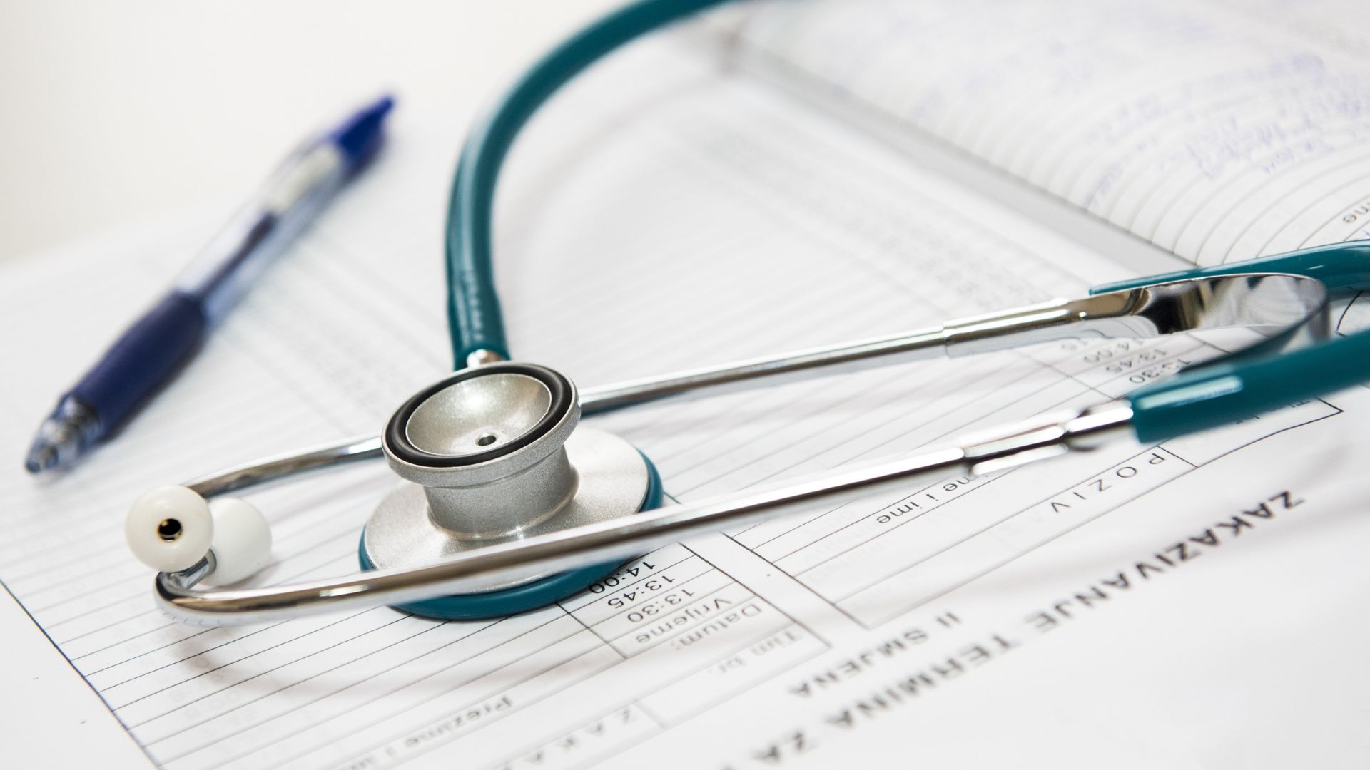 Stethoscope and pen resting on medical chart or patient form